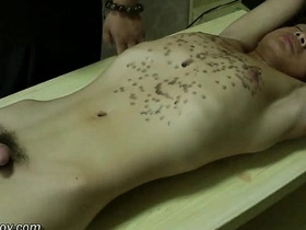 Young Asian man with a fit body gets hot wax treatment