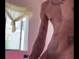 Young gay guy strips and shows off his muscles before ejaculating.