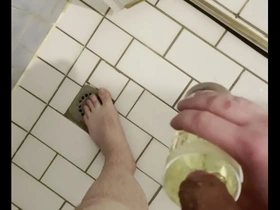 Gay man enjoys golden shower with glass of urine