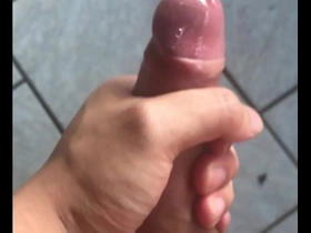 Asian man reaches climax while masturbating.