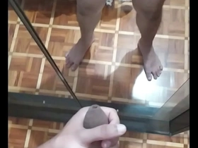 Solo boy shows off his big uncut cock in the mirror