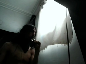 A hirsute transsexual woman enjoys deep throat penetration with a dildo for 12 minutes.