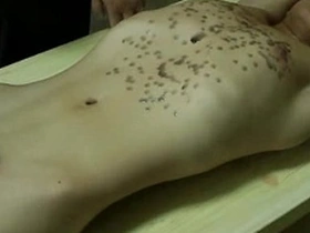 Young Asian man with a fit body gets hot wax treatment