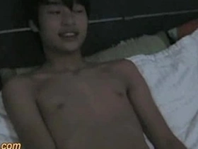 Small Asian boy with a big dick masturbates.