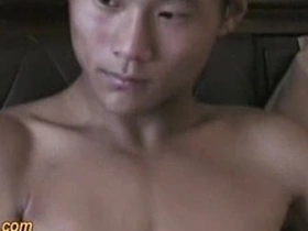 A slim dark-skinned young Asian man masturbates.